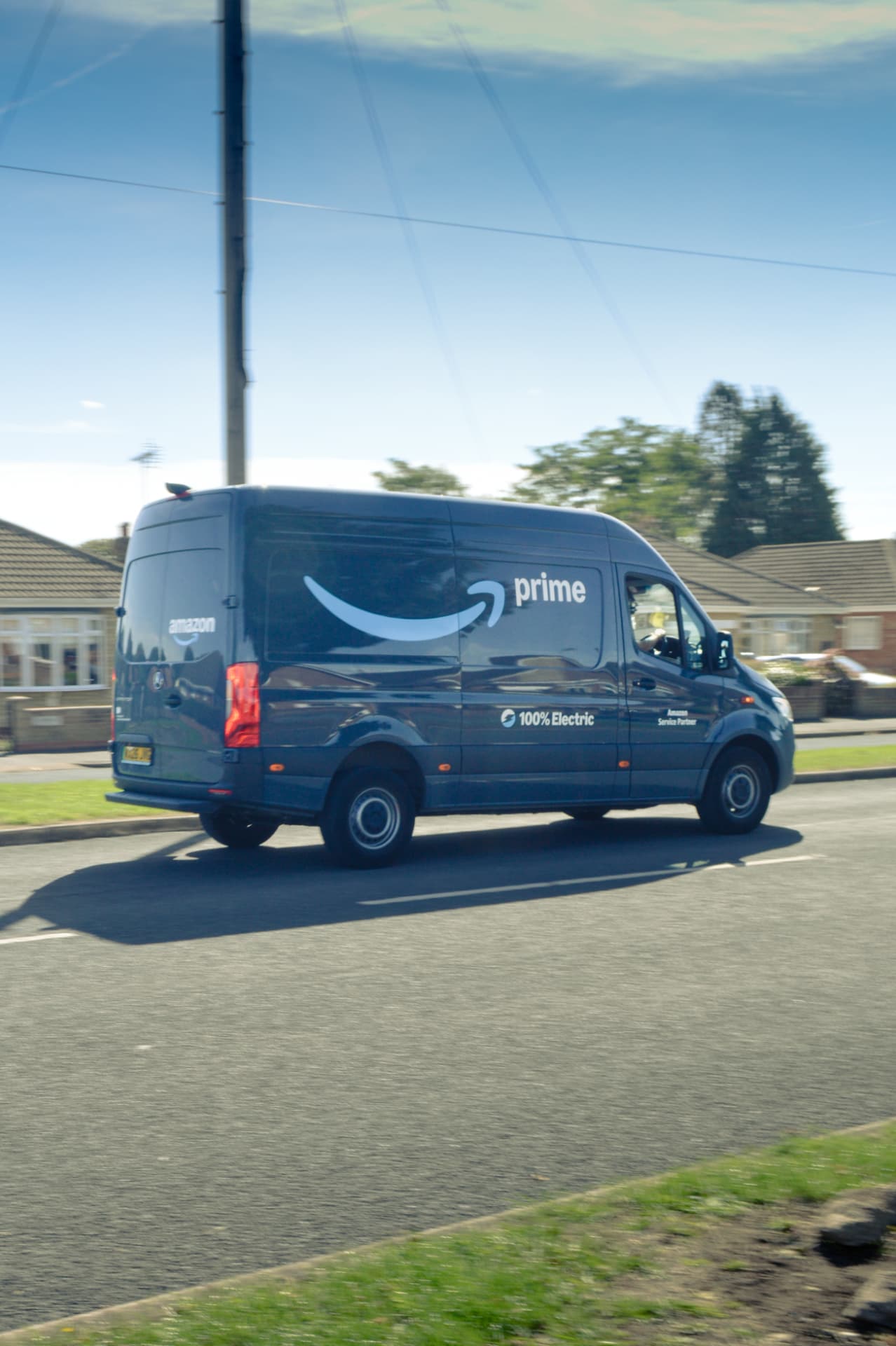 A delivery van parked on a residential street in the evening light